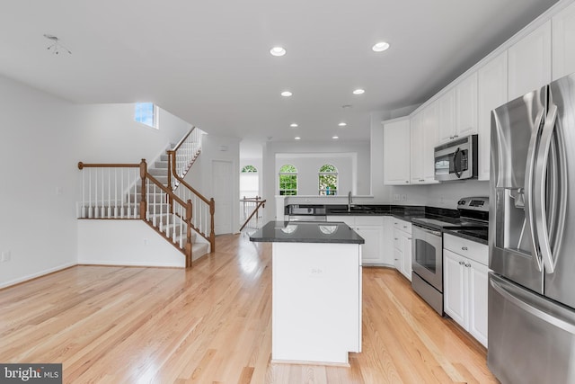5454 Patuxent Knoll Pl, Alexandria, VA 22312 - kitchen featuring stainless steel appliances, white cabinetry, light wood-type flooring, recessed lighting, and a kitchen island