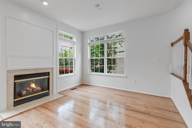 5454 Patuxent Knoll Pl, Alexandria, VA 22312 - unfurnished living room with a high end fireplace, wood finished floors, baseboards, and stairs