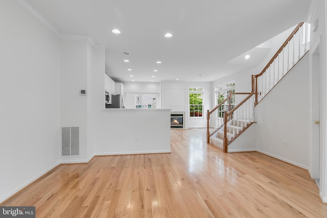 5454 Patuxent Knoll Pl, Alexandria, VA 22312 - unfurnished living room featuring stairs, recessed lighting, light wood-type flooring, baseboards, and a glass covered fireplace
