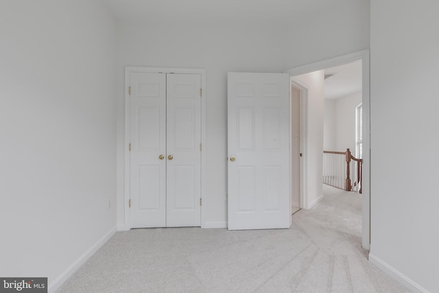 5454 Patuxent Knoll Pl, Alexandria, VA 22312 - unfurnished bedroom featuring light colored carpet, a closet, and baseboards