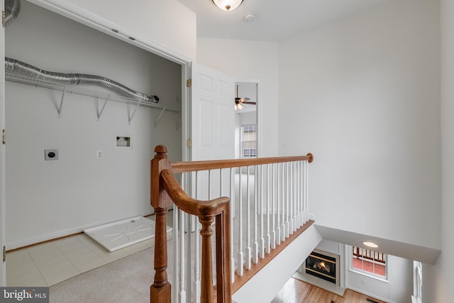 5454 Patuxent Knoll Pl, Alexandria, VA 22312 - laundry room with hookup for an electric dryer, washer hookup, a glass covered fireplace, baseboards, and healthy amount of natural light