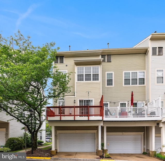 5454 Patuxent Knoll Pl, Alexandria, VA 22312 - rear view of house with a garage, a balcony, and concrete driveway