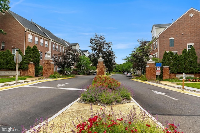 5454 Patuxent Knoll Pl, Alexandria, VA 22312 - view of asphalt road featuring sidewalks, curbs, traffic signs, and a residential view