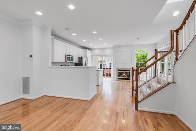 5454 Patuxent Knoll Pl, Alexandria, VA 22312 - kitchen with stainless steel appliances, baseboards, white cabinetry, recessed lighting, and light wood-style flooring