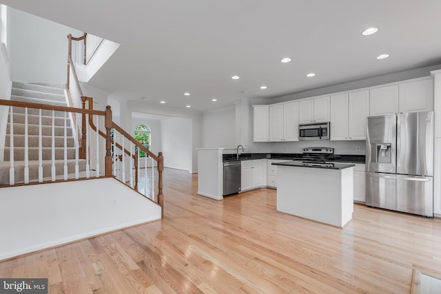 5454 Patuxent Knoll Pl, Alexandria, VA 22312 - kitchen featuring stainless steel appliances, a sink, recessed lighting, white cabinets, and light wood finished floors