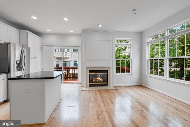 5454 Patuxent Knoll Pl, Alexandria, VA 22312 - kitchen with healthy amount of natural light, white cabinetry, a fireplace, light wood-style floors, and recessed lighting