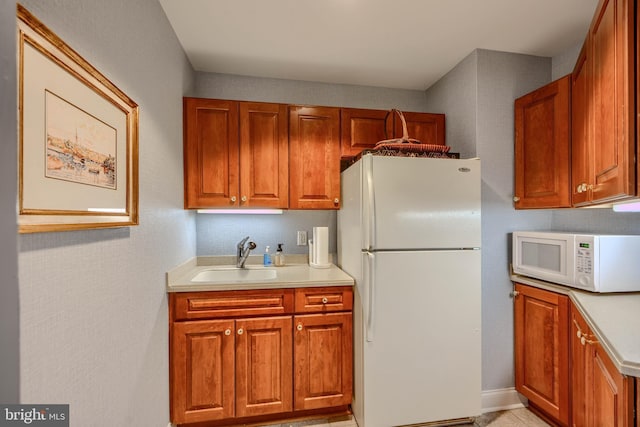 12251 Roundwood Rd Unit 301, Lutherville Timonium, MD 21093 - kitchen featuring white appliances, light countertops, and brown cabinets