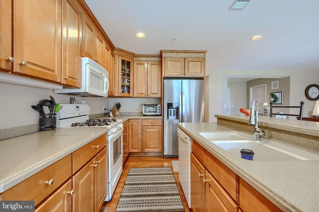 12251 Roundwood Rd Unit 301, Lutherville Timonium, MD 21093 - kitchen with white appliances, recessed lighting, glass insert cabinets, and light wood finished floors