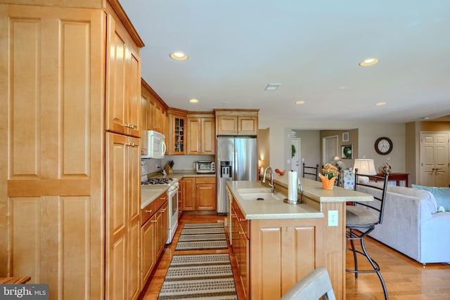 12251 Roundwood Rd Unit 301, Lutherville Timonium, MD 21093 - kitchen with white appliances, light countertops, a kitchen breakfast bar, recessed lighting, and light wood finished floors