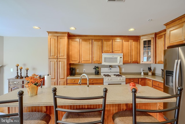 12251 Roundwood Rd Unit 301, Lutherville Timonium, MD 21093 - kitchen featuring white appliances, a breakfast bar, recessed lighting, light countertops, and glass insert cabinets