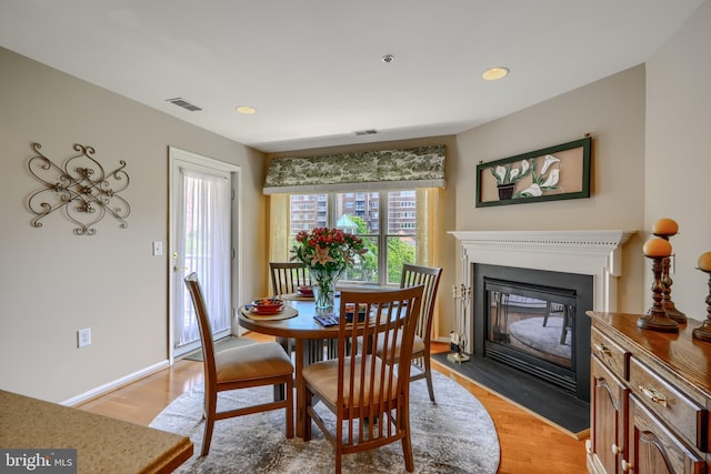 12251 Roundwood Rd Unit 301, Lutherville Timonium, MD 21093 - dining space with a fireplace with flush hearth, light wood-type flooring, and recessed lighting