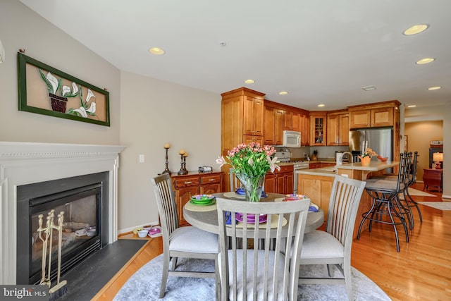 12251 Roundwood Rd Unit 301, Lutherville Timonium, MD 21093 - dining room with recessed lighting, light wood-style floors, and a glass covered fireplace