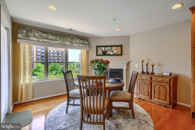 12251 Roundwood Rd Unit 301, Lutherville Timonium, MD 21093 - dining room featuring a glass covered fireplace, recessed lighting, and light wood-style flooring