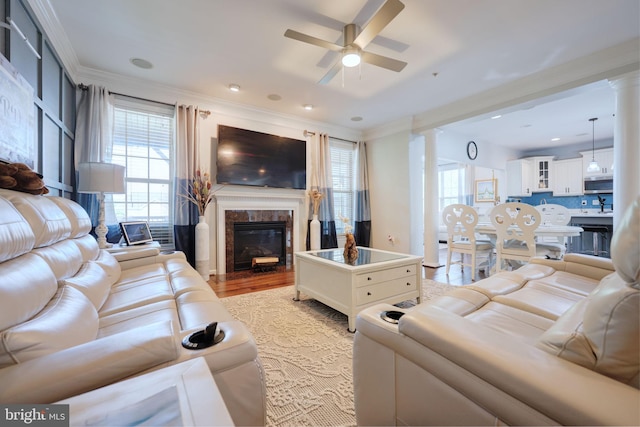 2703 Brownlee Ct, Lanham, MD 20706 - living area with a ceiling fan, healthy amount of natural light, ornamental molding, a high end fireplace, and decorative columns