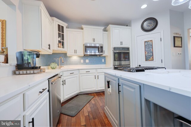 2703 Brownlee Ct, Lanham, MD 20706 - kitchen with stainless steel appliances, dark wood-style floors, a sink, white cabinetry, and recessed lighting