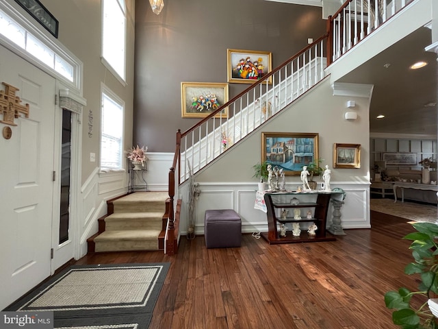 2703 Brownlee Ct, Lanham, MD 20706 - foyer with stairs, hardwood / wood-style flooring, a towering ceiling, a decorative wall, and wainscoting