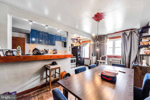 6720 Dorel St, Philadelphia, PA 19142 - dining space with wood finished floors, a chandelier, and a wall mounted air conditioner