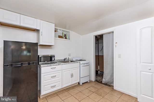 3826 W Bay Ave, Baltimore, MD 21225 - kitchen featuring freestanding refrigerator, stainless steel microwave, white range, a sink, and open shelves