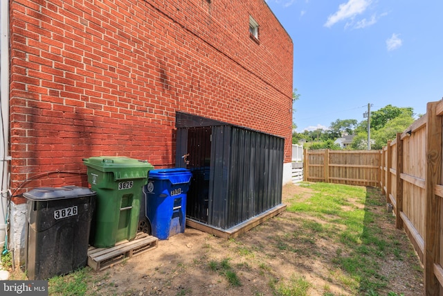 3826 W Bay Ave, Baltimore, MD 21225 - view of side of home with brick siding and a fenced backyard