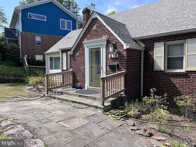 418 Boyd Ave, Takoma Park, MD 20912 - back of property featuring brick siding, a chimney, a shingled roof, and a patio area