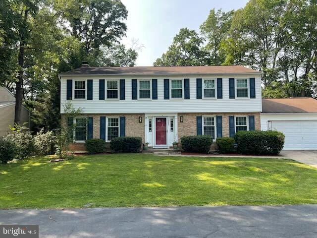 10253 Marshall Pond Rd, Burke, VA 22015 - colonial home featuring an attached garage, a front yard, brick siding, and driveway