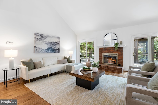 4920 Sunset Ln, Annandale, VA 22003 - living room featuring light wood-style floors, a brick fireplace, and high vaulted ceiling