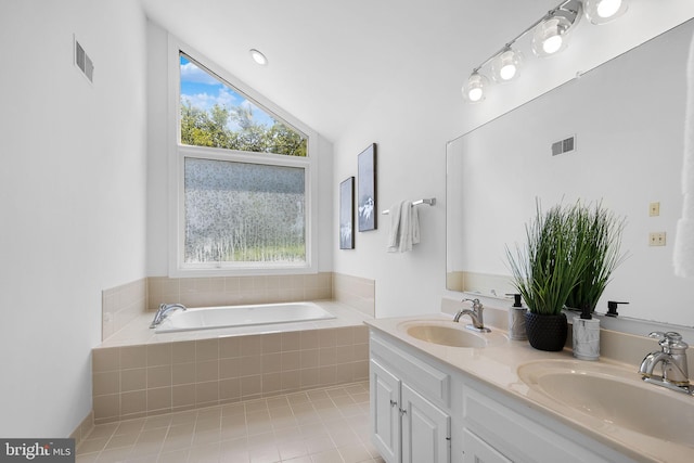 4920 Sunset Ln, Annandale, VA 22003 - bathroom with vaulted ceiling, a garden tub, double vanity, and tile patterned flooring