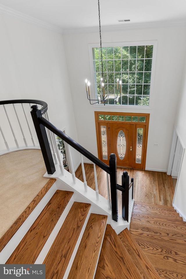 4920 Sunset Ln, Annandale, VA 22003 - stairway with a chandelier, ornamental molding, wood finished floors, and a high ceiling