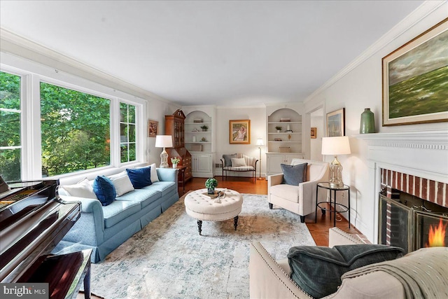 1771 Hunters Cir, West Chester, PA 19380 - living room featuring a brick fireplace, built in features, ornamental molding, and wood finished floors