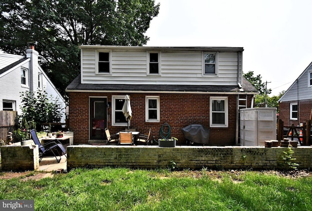 121 Shaffer Rd, King Of Prussia, PA 19406 - back of property featuring brick siding, a patio, and a shingled roof