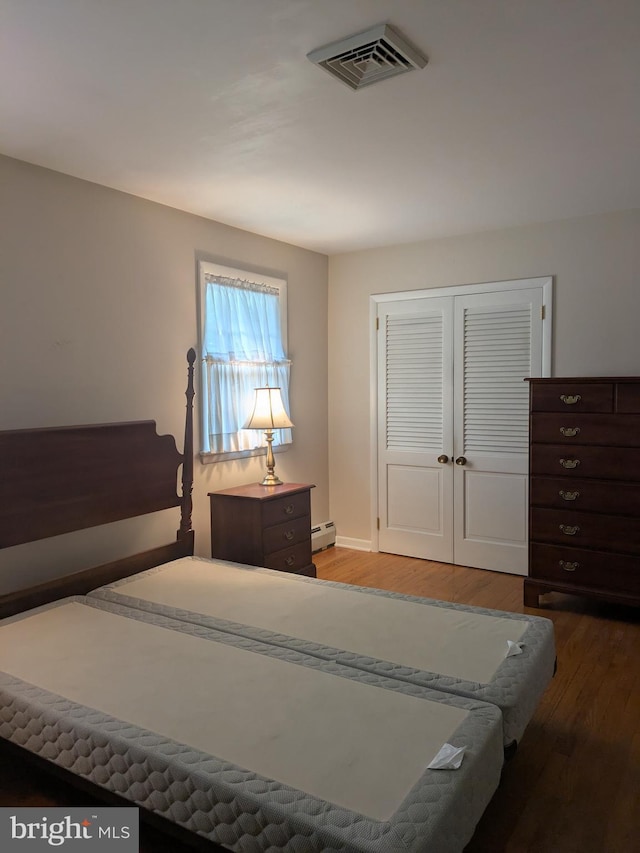 3339 Bruun Ave, Vineland, NJ 08360 - bedroom featuring a baseboard heating unit, wood finished floors, and a closet