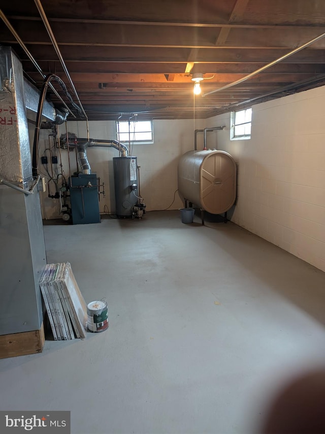 3339 Bruun Ave, Vineland, NJ 08360 - basement featuring oil tank, water heater, healthy amount of natural light, and heating unit