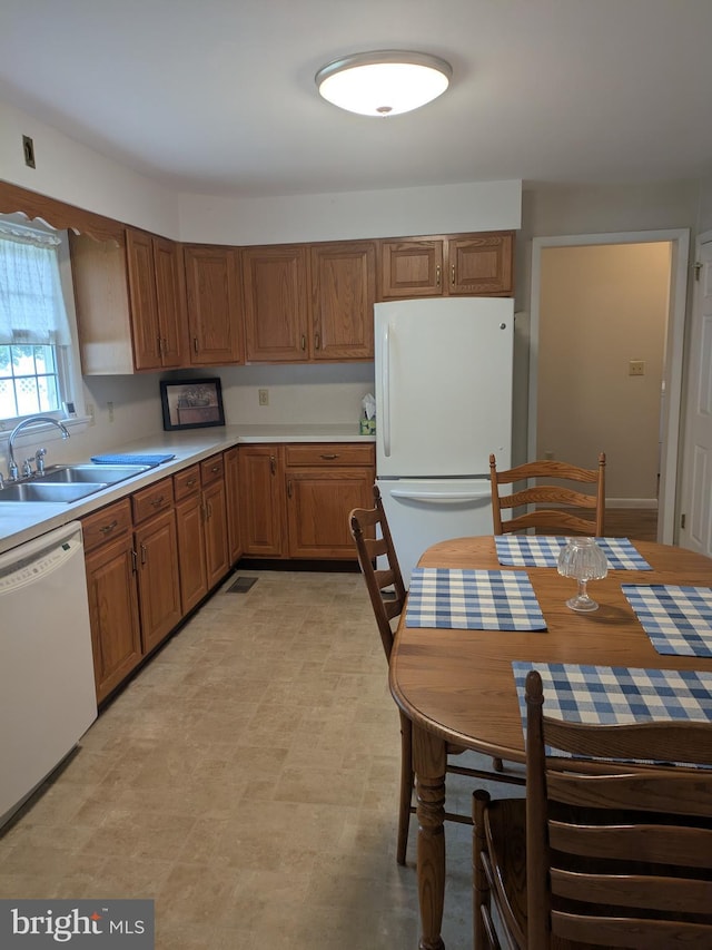 3339 Bruun Ave, Vineland, NJ 08360 - kitchen featuring white appliances, brown cabinetry, and light countertops