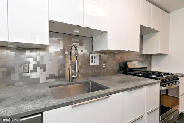 3600 Conshohocken Ave Unit 705, Philadelphia, PA 19131 - kitchen featuring stainless steel range with gas cooktop, white cabinets, decorative backsplash, and light stone counters