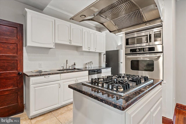 1360 Perry Pl NW, Washington, DC 20010 - kitchen featuring appliances with stainless steel finishes, a sink, decorative backsplash, crown molding, and white cabinets