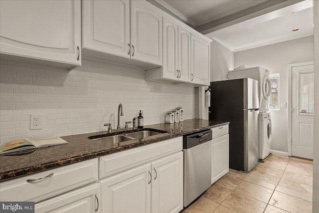 1360 Perry Pl NW, Washington, DC 20010 - kitchen featuring appliances with stainless steel finishes, a sink, stacked washer and clothes dryer, crown molding, and tasteful backsplash