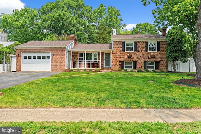 4802 Eubank St, Alexandria, VA 22309 - split level home featuring a chimney, an attached garage, brick siding, asphalt driveway, and covered porch