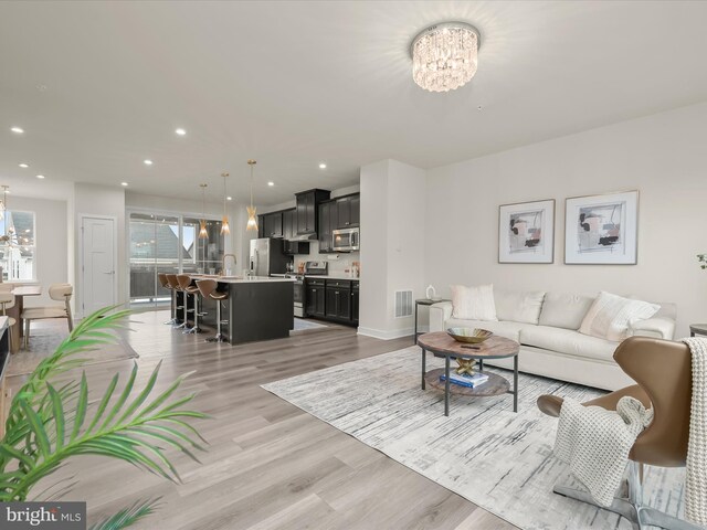 7330 Isabella Rd, Laurel, MD 20723 - living area featuring a chandelier, light wood-style floors, and recessed lighting