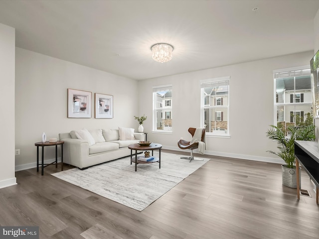 7330 Isabella Rd, Laurel, MD 20723 - living area with healthy amount of natural light, wood finished floors, and a chandelier