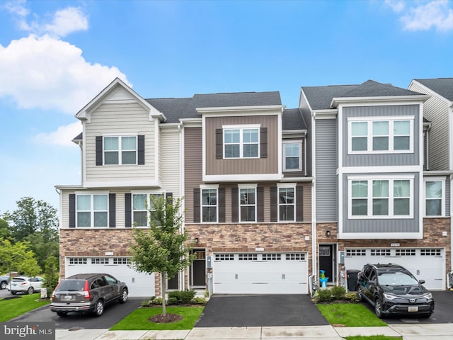 7330 Isabella Rd, Laurel, MD 20723 - view of property with stone siding, driveway, and an attached garage
