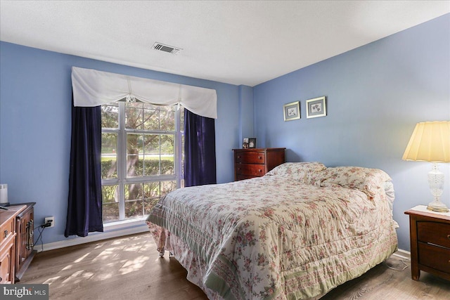 20273 Beechwood Ter Unit 103, Ashburn, VA 20147 - bedroom with wood finished floors and baseboards