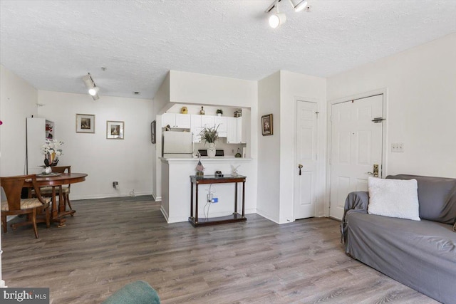 20273 Beechwood Ter Unit 103, Ashburn, VA 20147 - living area with a textured ceiling, wood finished floors, and baseboards