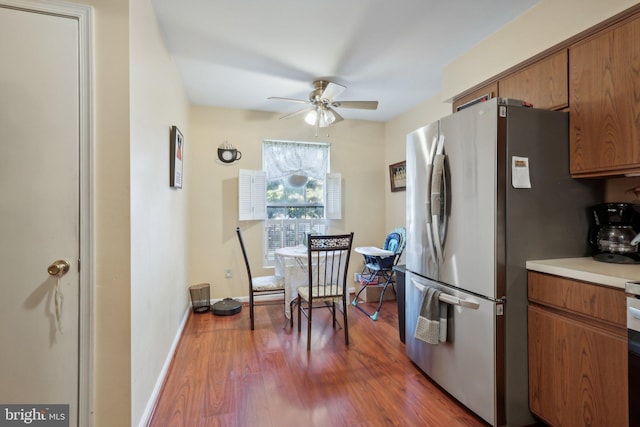226 Troon Ct, Royersford, PA 19468 - kitchen with freestanding refrigerator, ceiling fan, brown cabinets, wood finished floors, and light countertops