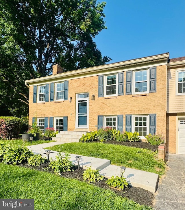 4909 King David Blvd, Annandale, VA 22003 - raised ranch featuring a chimney, brick siding, and a garage
