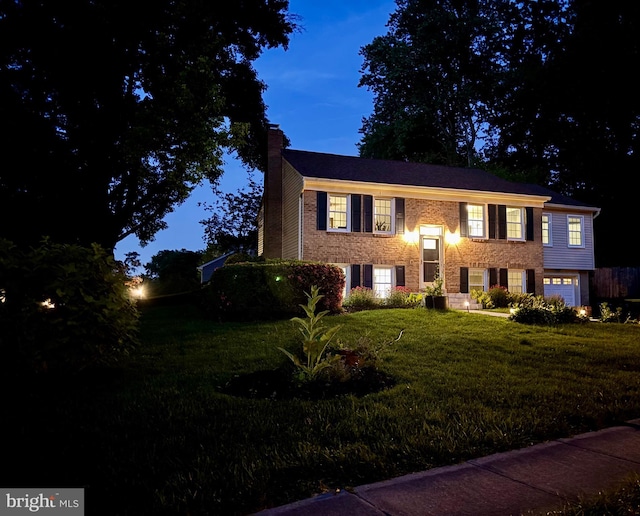 4909 King David Blvd, Annandale, VA 22003 - split foyer home with a chimney, a front yard, a garage, and brick siding