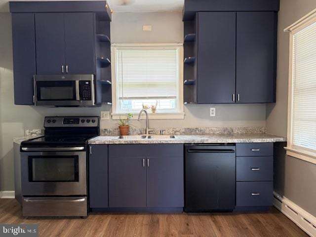 2329 Canby St, Harrisburg, PA 17103 - kitchen with stainless steel appliances, open shelves, a baseboard heating unit, a sink, and wood finished floors