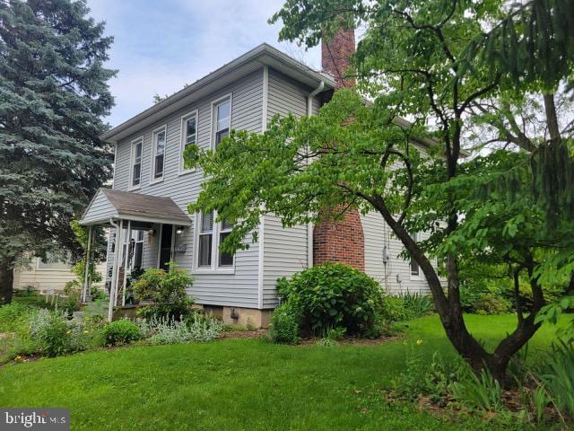 2329 Canby St, Harrisburg, PA 17103 - view of home's exterior featuring a chimney and a lawn