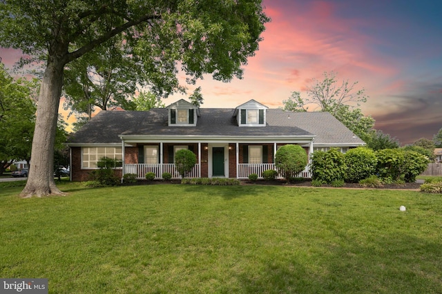 1101 Cherry Ln, Cinnaminson, NJ 08077 - cape cod home featuring a porch, brick siding, and a front lawn
