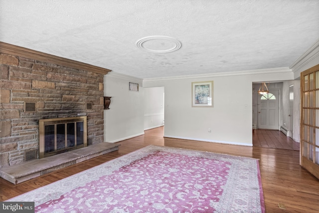 1101 Cherry Ln, Cinnaminson, NJ 08077 - unfurnished living room with wood finished floors, a textured ceiling, a stone fireplace, baseboards, and crown molding