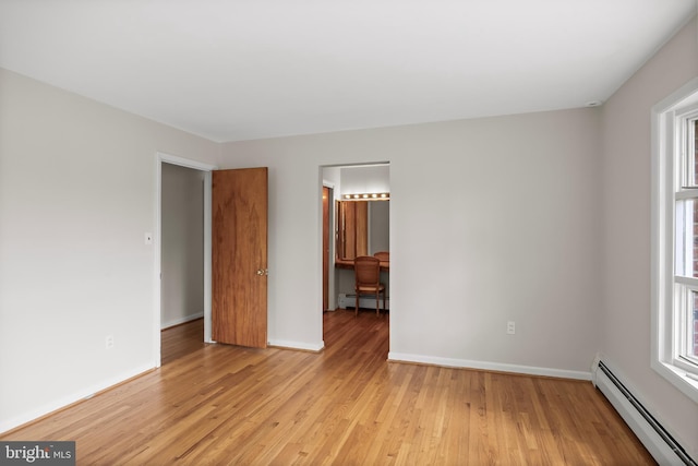 1101 Cherry Ln, Cinnaminson, NJ 08077 - spare room with a baseboard radiator, light wood-type flooring, and baseboards